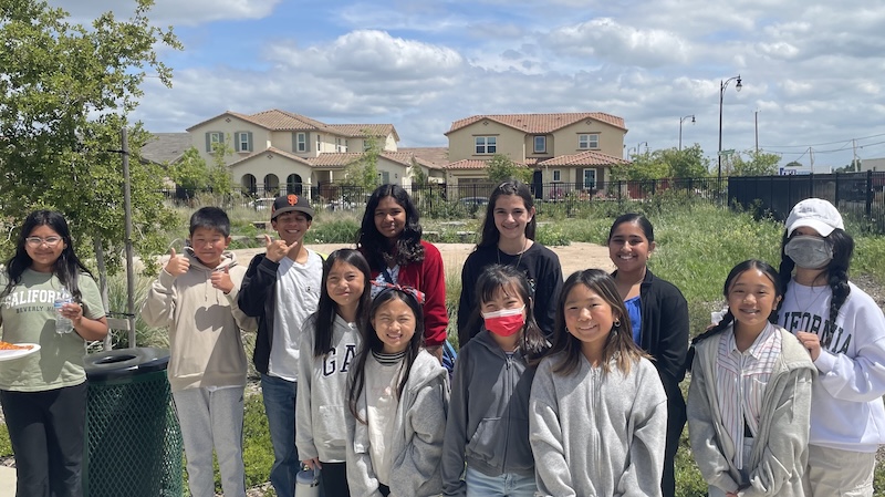 Group of children gathered in front of a school