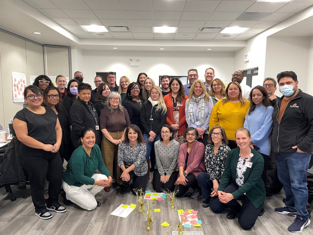 A more formal picture of the staff with the artifacts from their SEL activity.